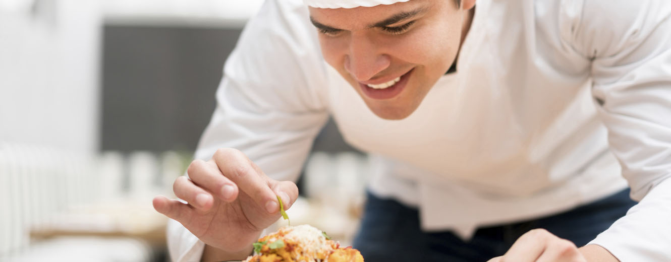 Chef decorating a plate at a restaurant